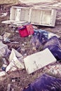 Illegal dumping with cardboard boxes, plastic bags and domestic appliances abandoned in nature