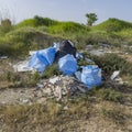 Illegal dumping and garbage in the field Royalty Free Stock Photo