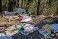 Illegal dumping and littering - piles of supermarket catalogues in the bush