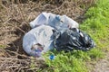 Illegal dumping with plastic bags abandoned in nature Royalty Free Stock Photo