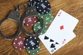 Illegal gambling concept of blackjack with betting chips and handcuffs