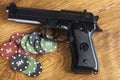 Illegal gambling concept of handgun with betting chips