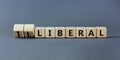 Illiberal or liberal symbol. Businessman turns wooden cubes and changes the word illiberal to liberal. Beautiful grey background. Royalty Free Stock Photo