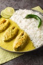 Illish or Hilsa fish cooking with mustard seed sauce served with white rice closeup on the plate. Vertical Royalty Free Stock Photo