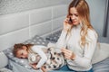 Mother with her illnes daughter in a bedroom