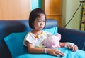 Illness asian child admitted in hospital while saline intravenous IV on hand .