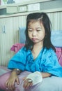 Illness asian child admitted in hospital with saline iv drip on