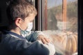 Illness child on home quarantine. Boy wear protective medical masks