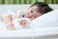 Illness child in hospital, saline intravenous (IV) on hand asian Royalty Free Stock Photo