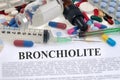 Bronchiolitis word written in French with drugs and syringes