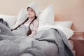 Sick emotionless girl lying in bed Royalty Free Stock Photo