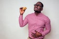 Illness sad african american man put hand on pain abdomen of hamburger.handsome and young afro man in a stylish shirt Royalty Free Stock Photo