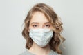 Illness woman in medical face mask on white portrait