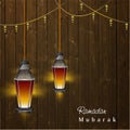 Illuminate Arabic Fanoose String Light Hanging on Wooden Background for Islamic Festival of Ramadan Mubarak Celebration Royalty Free Stock Photo