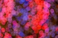 Red, purple, pink, blue, magenta, green and gold bokeh on dark background. Royalty Free Stock Photo