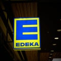 Illuminated advertisement of the food discounter Edeka in the evening