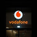 Illuminated advertisement of the mobile phone provider Vodafone in Berlin in the evening