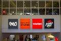 Illuminated advertising logos above the escalators in the large shopping mall Lote, R. do MunicÃÂ­pio in Albuferia Portugal