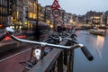 Illuminated Amsterdam canals atmosphere,touristic boats, architecture and bikes