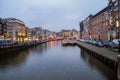 Illuminated Amsterdam canals view,touristic boats and traditional architecture