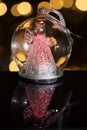 Illuminated angel figure in glass bulb, soft boke christmas ligh Royalty Free Stock Photo