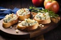 illuminated apple gorgonzola bruschettas with sprigs of thyme on a wooden crate