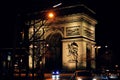 Illuminated Arc de Triomphe at night in the center of Paris