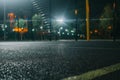 Illuminated basketball playground with red pavement, modern new basketball net Royalty Free Stock Photo