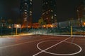 Illuminated basketball playground with red pavement, modern new basketball net Royalty Free Stock Photo