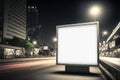 Illuminated blank billboard mockup on rectangular pedestal on city road at night Royalty Free Stock Photo