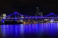 Illuminated blue lights on bridge with city skyline beyond Royalty Free Stock Photo