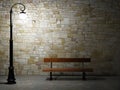 Illuminated brick wall with street light and bench