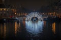 Illuminated bridge in Amsterdam at the Amstel in the Netherlands at night Royalty Free Stock Photo