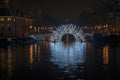 Illuminated bridge in Amsterdam at the Amstel in the Netherlands at night Royalty Free Stock Photo