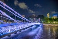 Illuminated bridge at night along Singapore river