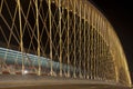 Illuminated bridge in Prague with riding tram