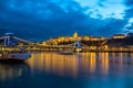 Illuminated building of Buda Castle and Chain bridge at night in Budapest. Royalty Free Stock Photo