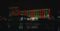 Illuminated building near the river at night