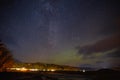 illuminated buildings and beautiful starry sky with northern lights