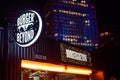 Illuminated burger stall sign at night on Southbank