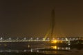 Illuminated cable-stayed bridge under construction with a tower crane over the Yamuna River at night. Signature Bridge. Delhi Royalty Free Stock Photo