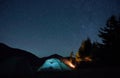 Illuminated camp tent under beautiful night sky with stars. Royalty Free Stock Photo