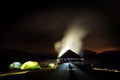 Illuminated camping tents at night in alpin zone