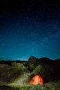 Illuminated camping tent under the night sky