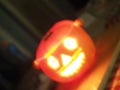 illuminated carved halloween pumpkin face with deliberate blur