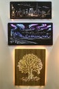 Illuminated carved pictures of landscape, cityscape and solitary broadleaf tree, made by LiGo company