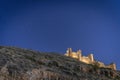 Illuminated castle on top of the mountain in the village of Albarracin at starry night. Teruel. Royalty Free Stock Photo
