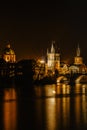 Illuminated Charles Bridge,Karluv most reflected in Vltava River. Evening panorama of Prague, Czech Republic. Long exposure city Royalty Free Stock Photo