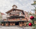 Illuminated Christmas fairground wooden kiosk with a lot of bright decorations, without logos