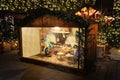 Illuminated Christmas market fair kiosk. Sale of mulled wine, Christmas trees and gingerbread Royalty Free Stock Photo